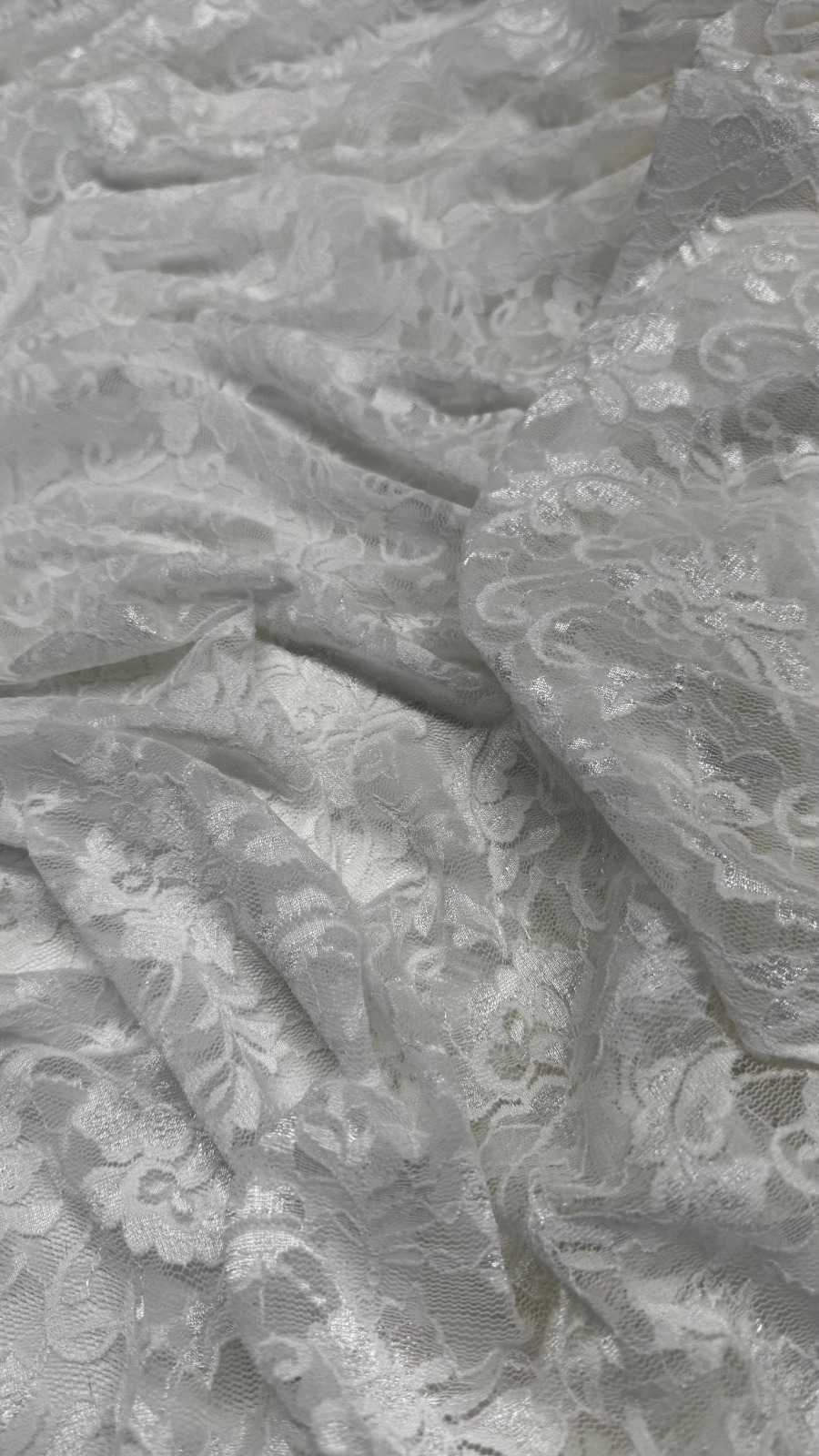 Pizzo strech bianco con motivo floreale in poliammide ed elastan
